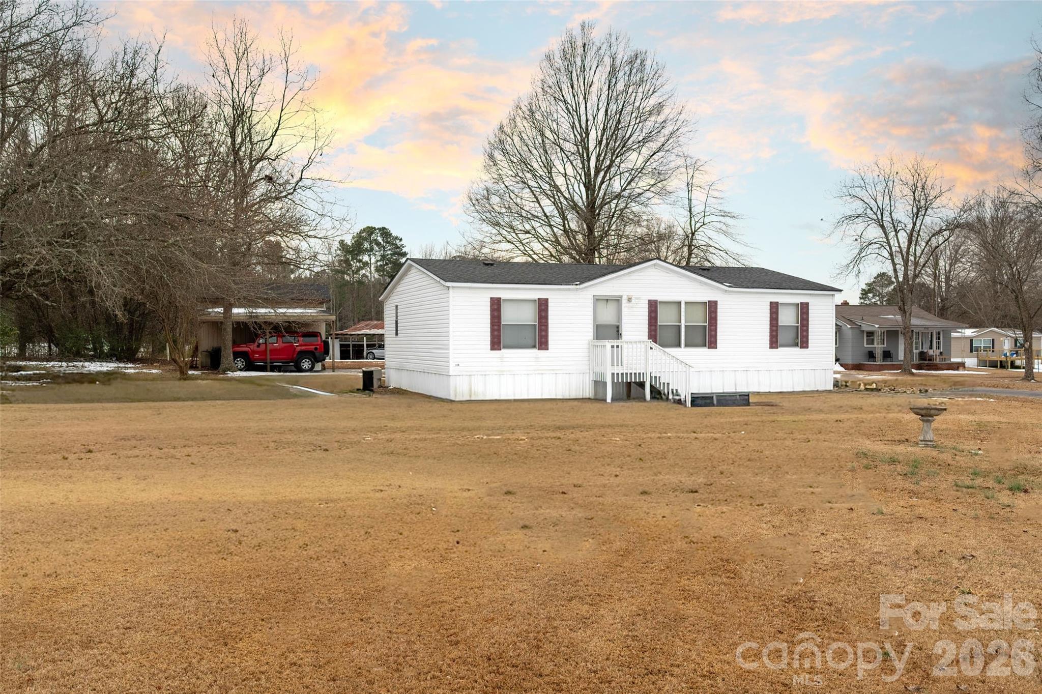 2748 Flat Creek Road Lancaster, SC 29720 - Photo 18 of 24 a front view of a house with a big yard and large trees