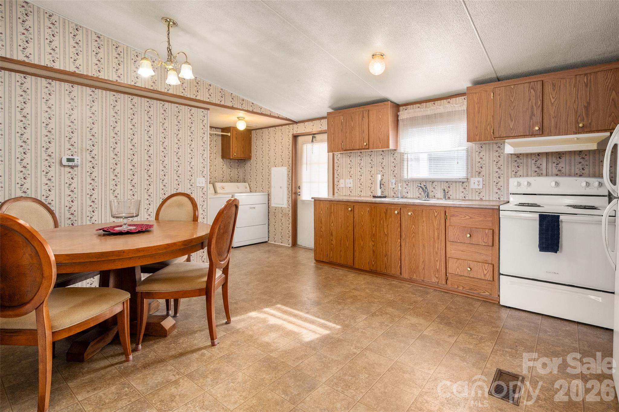 2748 Flat Creek Road Lancaster, SC 29720 - Photo 5 of 24 a kitchen with stainless steel appliances granite countertop a table chairs sink and cabinets