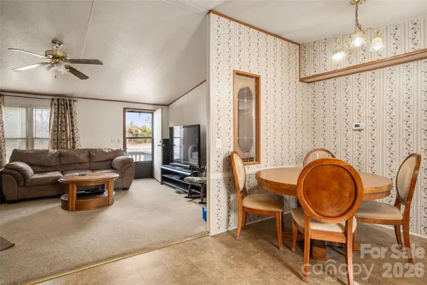 a living room with furniture a chandelier and a window