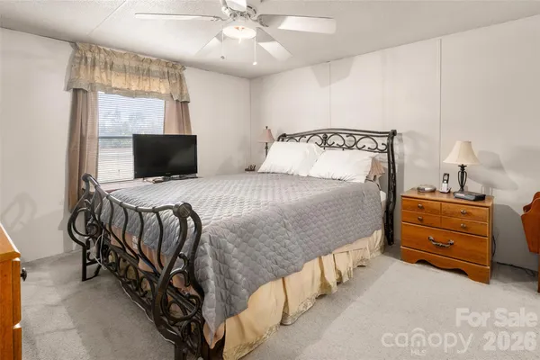 a bedroom with a bed and a tv