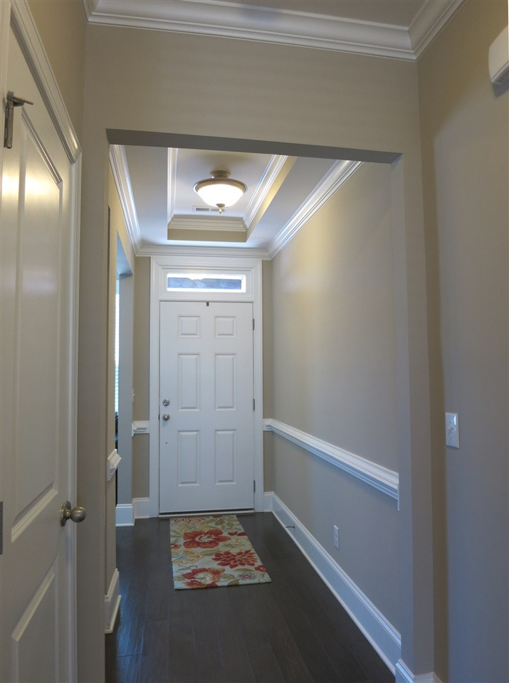 3916 Rock Rose Lane Raleigh, NC 27612 - Photo 2 of 25 View of the Foyer w/tray ceil & chair rail molding. Home features beautiful dark hardwood flrs, tall ceilings, crown molding, brushed nickel hardware/lighting, recessed lighting, tiled Baths throughout (and neutral carpet throughout 2nd & 3rd flrs). Foyer