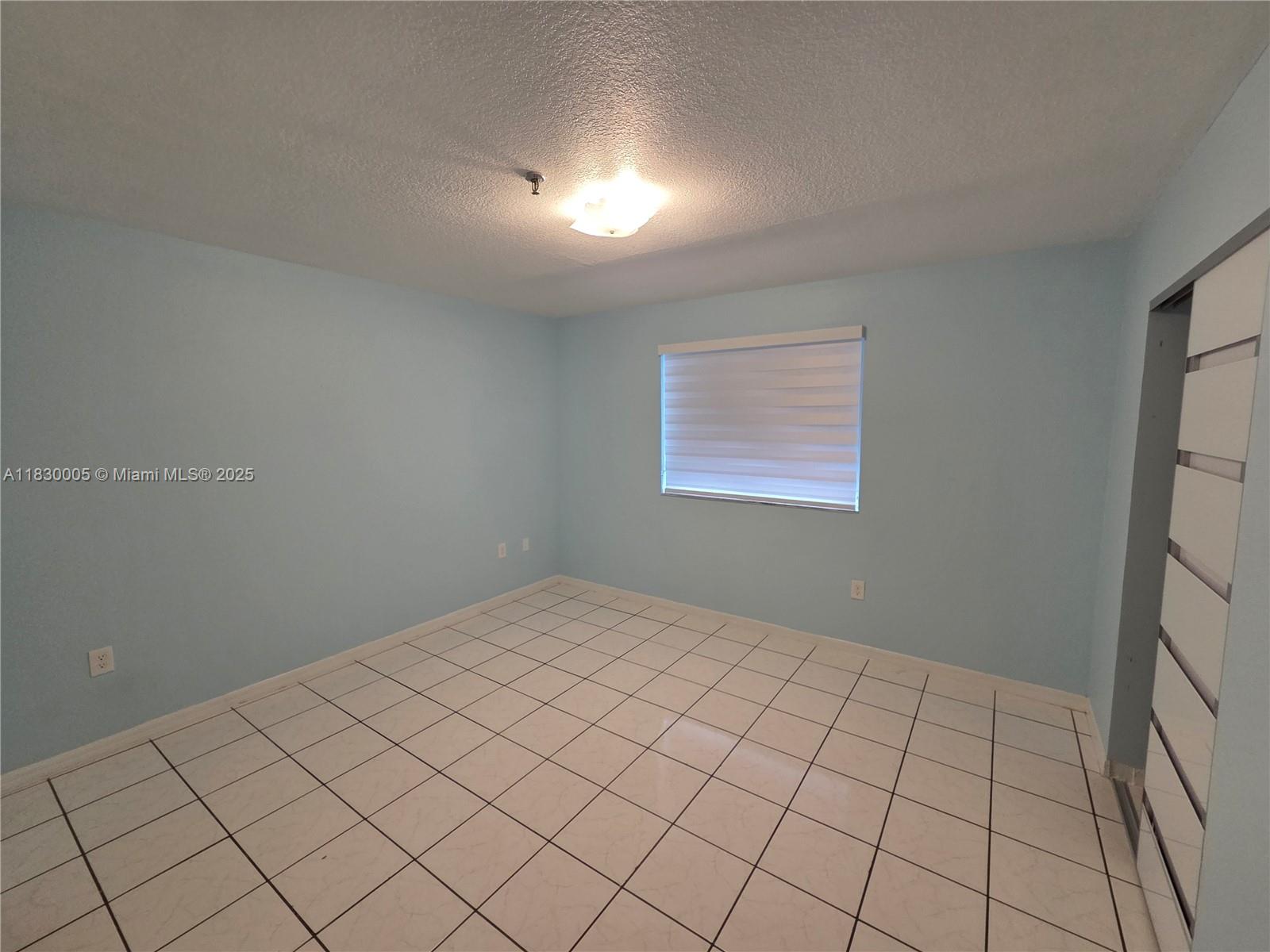 8360 Northwest 103rd Street, Unit 207E Hialeah Gardens, FL 33016 - Photo 15 of 25 a view of an empty room and window