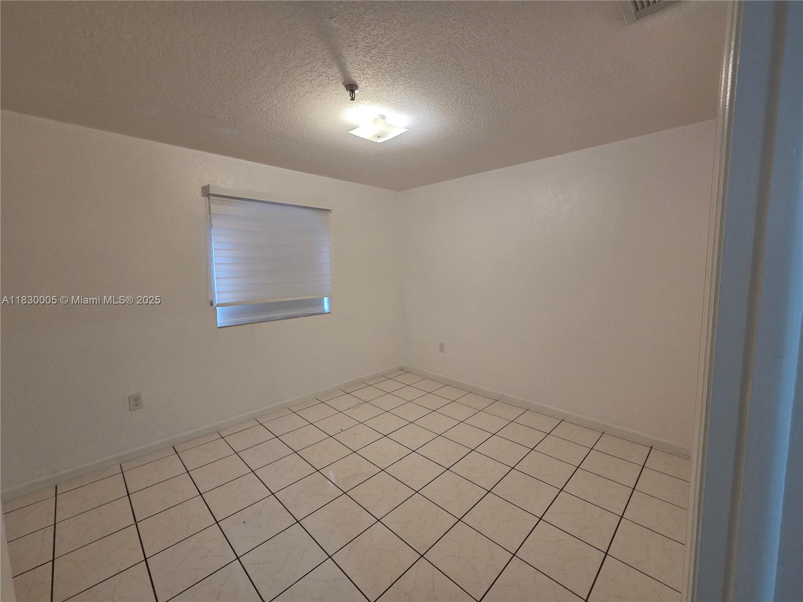 8360 Northwest 103rd Street, Unit 207E Hialeah Gardens, FL 33016 - Photo 18 of 25 a view of an empty room