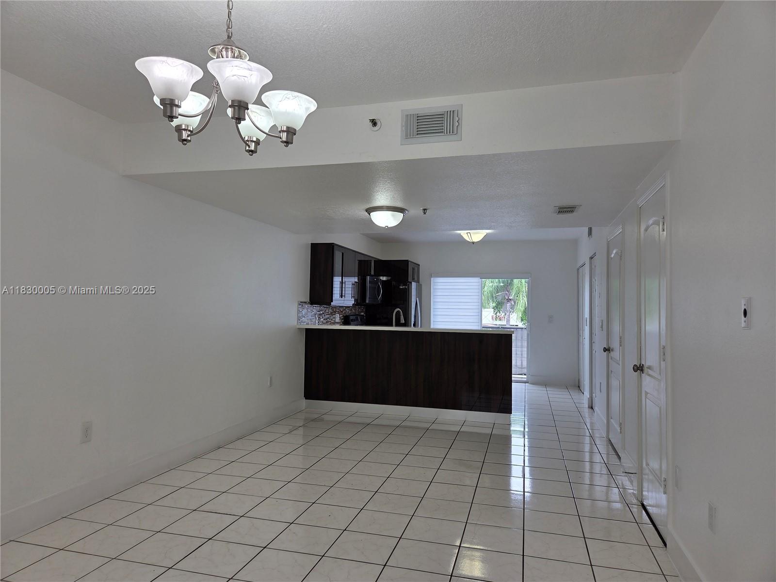 8360 Northwest 103rd Street, Unit 207E Hialeah Gardens, FL 33016 - Photo 7 of 25 a view of a kitchen with a sink and refrigerator