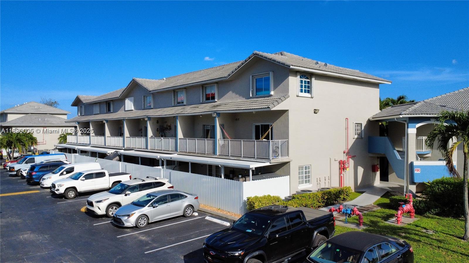 8360 Northwest 103rd Street, Unit 207E Hialeah Gardens, FL 33016 - Photo 10 of 25 a front view of a house with a yard