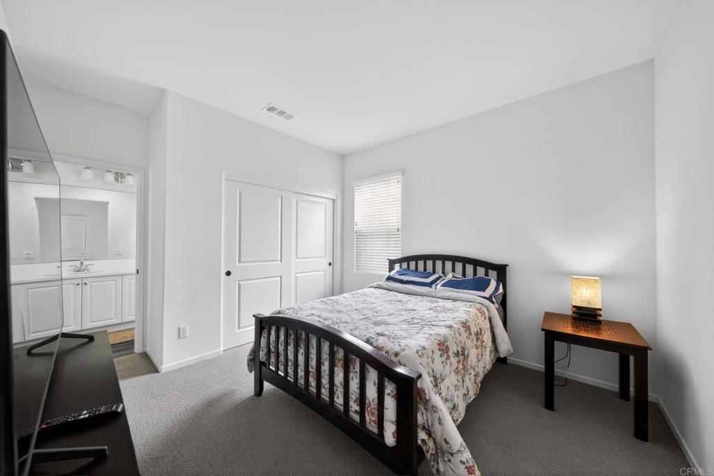 21641 Trail Ridge Drive Escondido, CA 92029 - Photo 22 of 43 a bedroom with a bed and a table in it