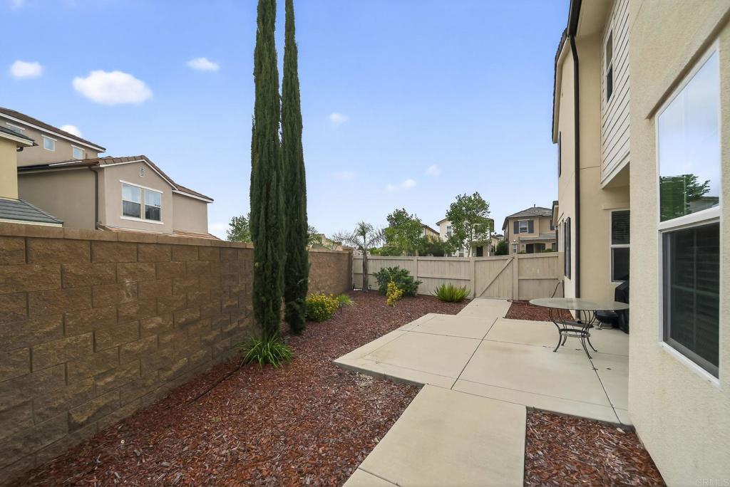 21641 Trail Ridge Drive Escondido, CA 92029 - Photo 30 of 43 a view of a patio with a table chairs and a floor to ceiling window