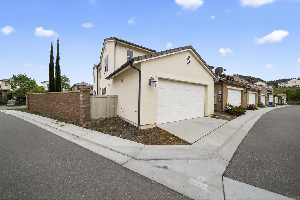 21641 Trail Ridge Drive Escondido, CA 92029 - Photo 31 of 43 a front view of a house with a yard and garage