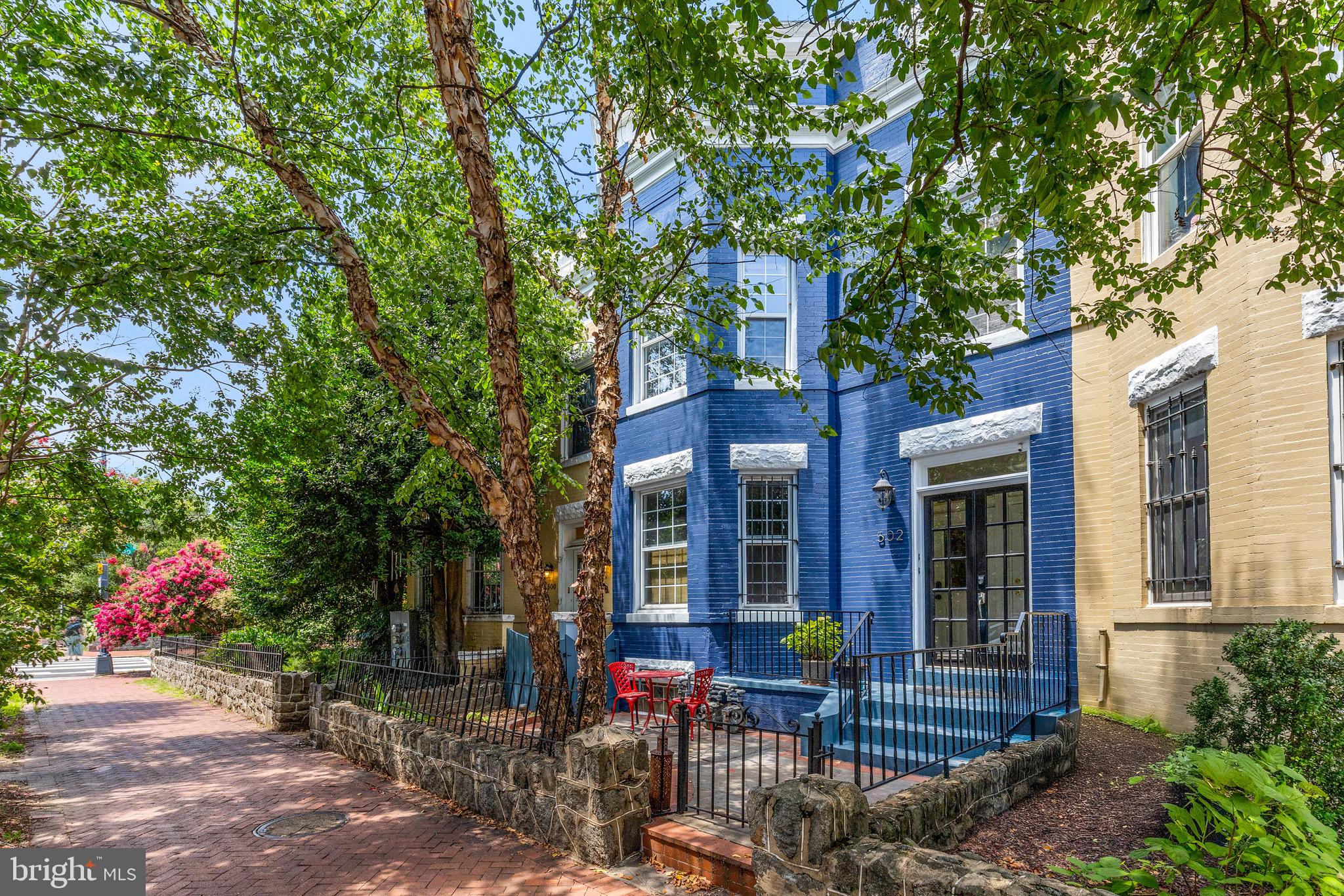 a view of a house with sitting area and garden