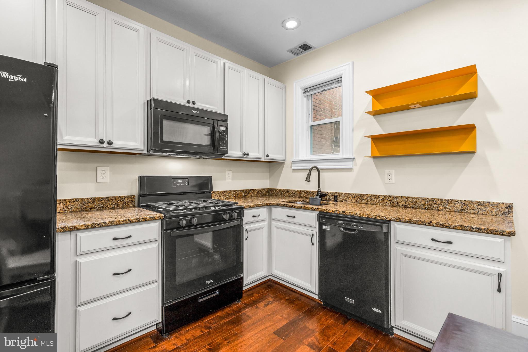 502 G Street Northeast Washington, DC 20002 - Photo 26 of 39 a kitchen with stainless steel appliances granite countertop a stove a sink and a microwave