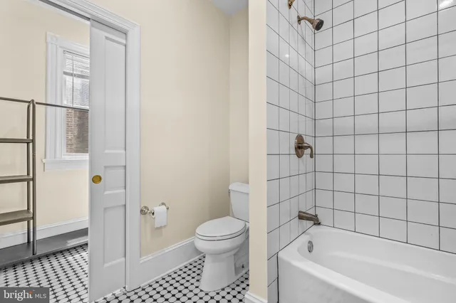 a bathroom with a bathtub and toilet