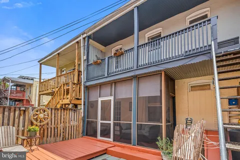 a view of a balcony with wooden floor