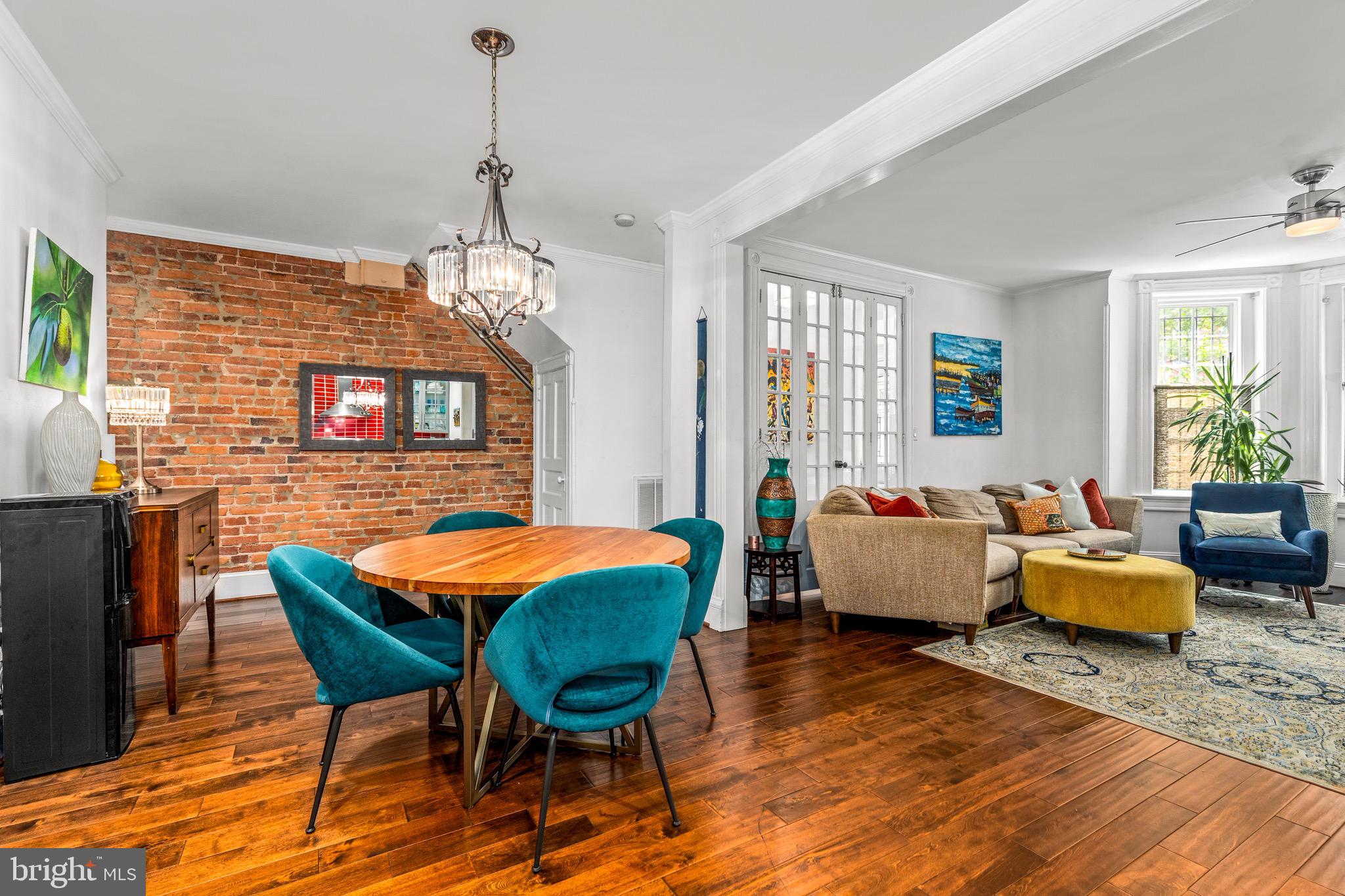 502 G Street Northeast Washington, DC 20002 - Photo 7 of 39 a dining room with wooden floor a chandelier a glass table and chairs