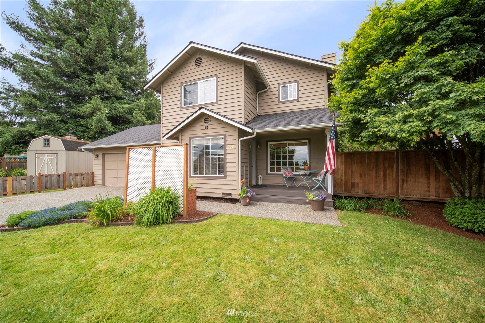 6018 Lowell Road Everett, WA 98203 - Photo 1 of 21 a front view of a house with garden