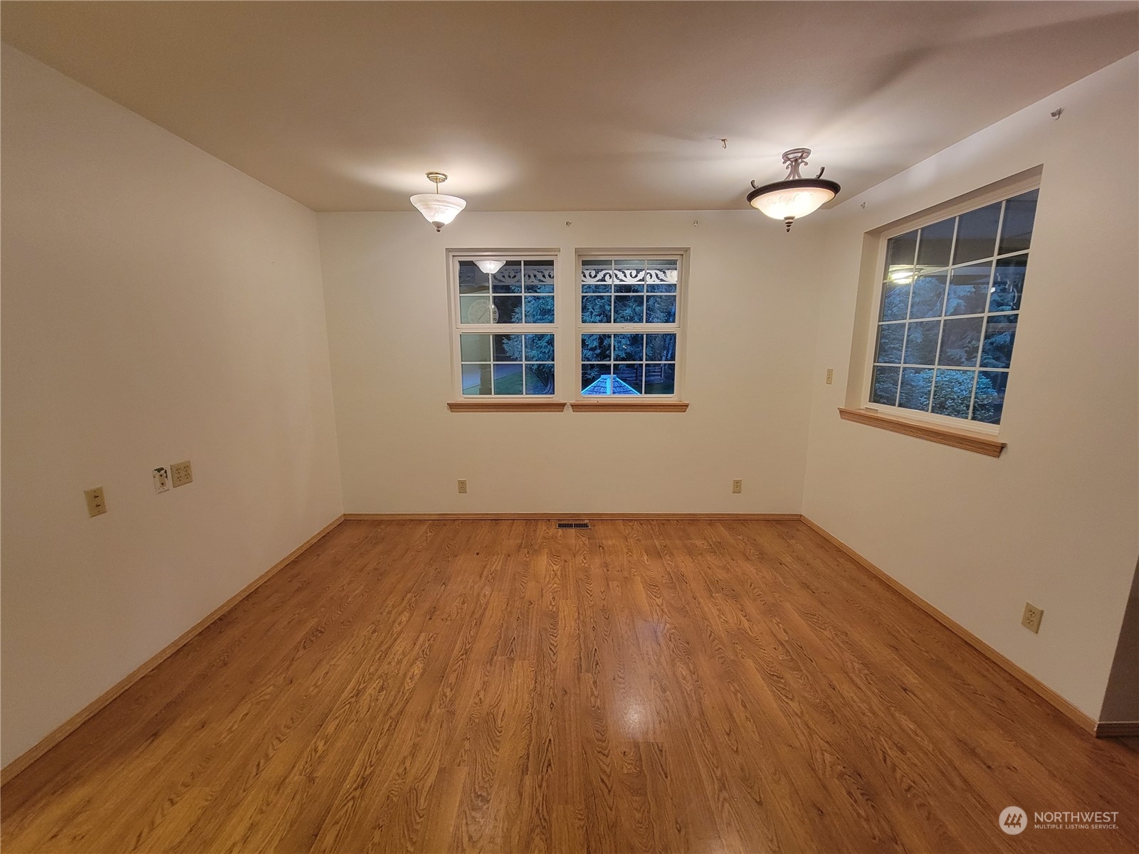 19618 Jordan Road Arlington, WA 98223 - Photo 20 of 32 an empty room with wooden floor and windows