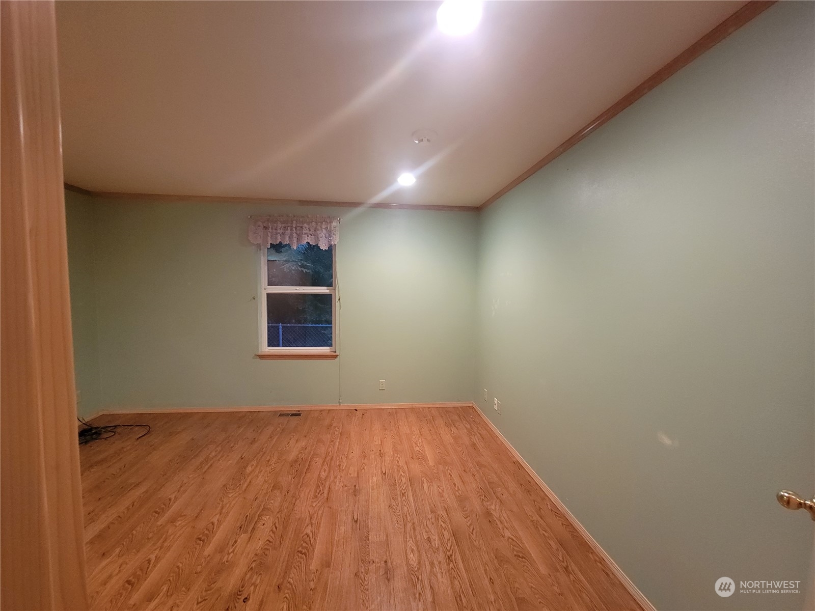 19618 Jordan Road Arlington, WA 98223 - Photo 23 of 32 an empty room with wooden floor and windows