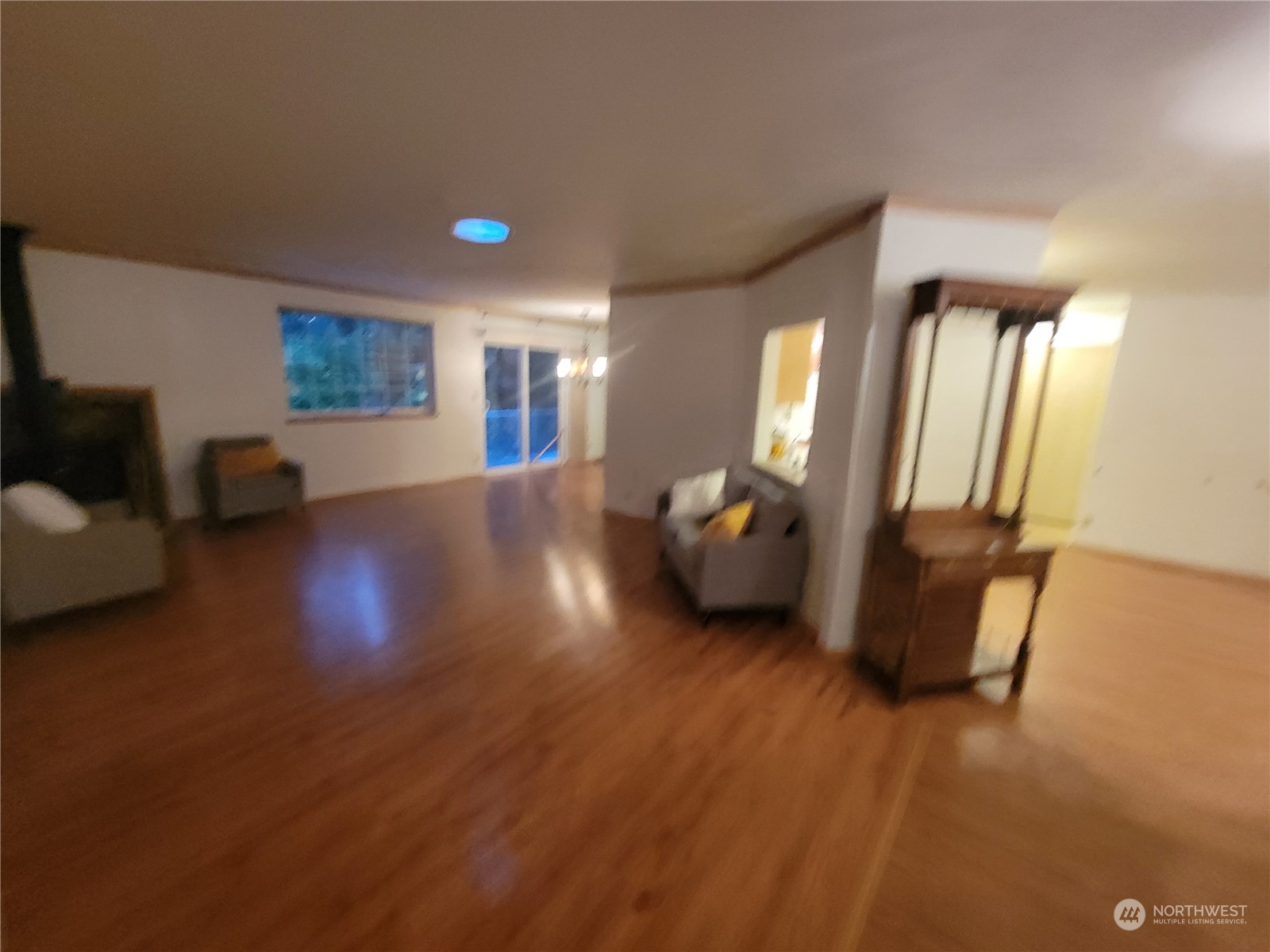19618 Jordan Road Arlington, WA 98223 - Photo 26 of 32 a view of an empty room with wooden floor and a window