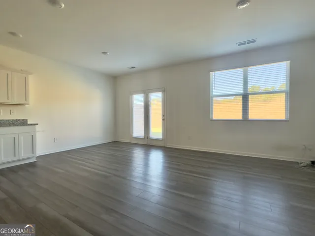 a view of kitchen view wooden floor and electronic appliances