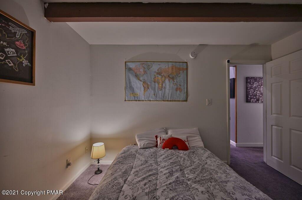 152 Canterbury Road Bushkill, PA 18324 - Photo 21 of 57 a bedroom with a bed and wooden floor