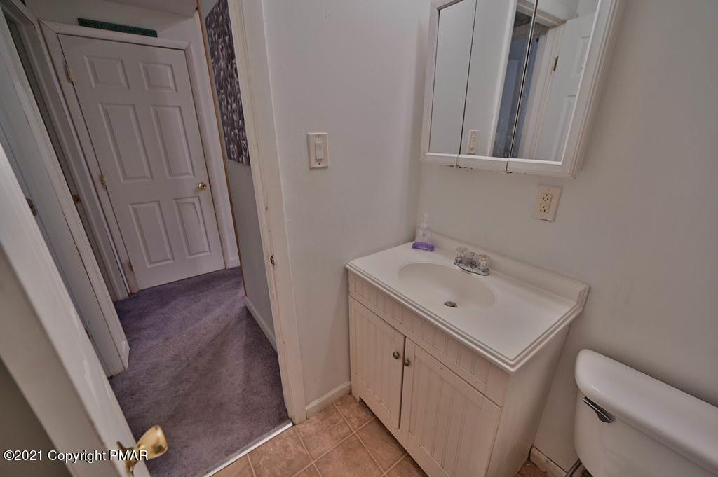 152 Canterbury Road Bushkill, PA 18324 - Photo 32 of 57 a bathroom with a sink a toilet and a mirror