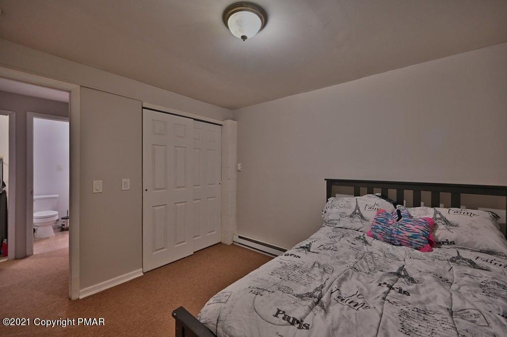 152 Canterbury Road Bushkill, PA 18324 - Photo 34 of 57 a bedroom with a bed and a night stand