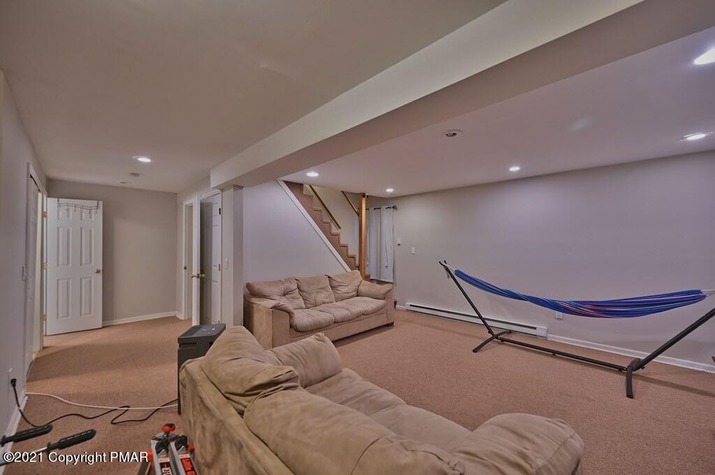 152 Canterbury Road Bushkill, PA 18324 - Photo 40 of 57 a living room with furniture gym equipment and a rug