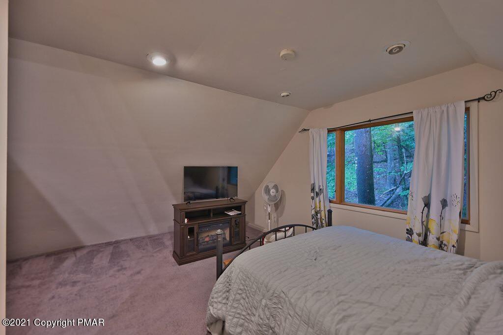 152 Canterbury Road Bushkill, PA 18324 - Photo 45 of 57 a bedroom with a bed and a flat screen tv