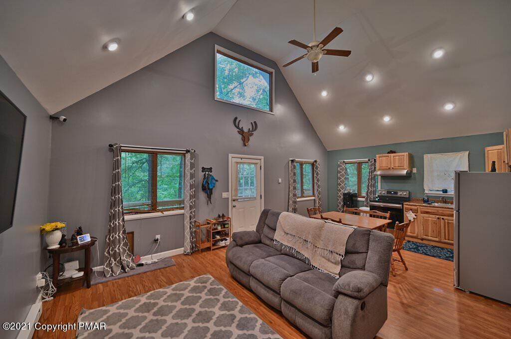 152 Canterbury Road Bushkill, PA 18324 - Photo 50 of 57 a living room with furniture a large window and stainless steel appliances