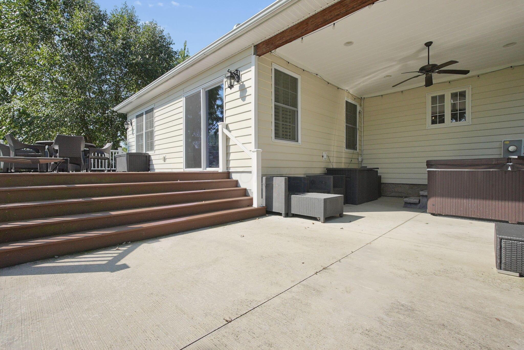 9435 Concord Road Powell, OH 43065 - Photo 61 of 77 Expansive concrete patio with a covered section and ceiling fan