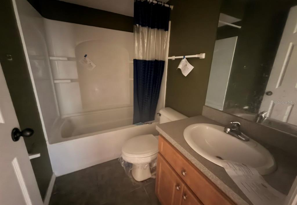 1221 Poe Street Inverness, FL 34450 - Photo 3 of 11 a bathroom with a sink a toilet and shower