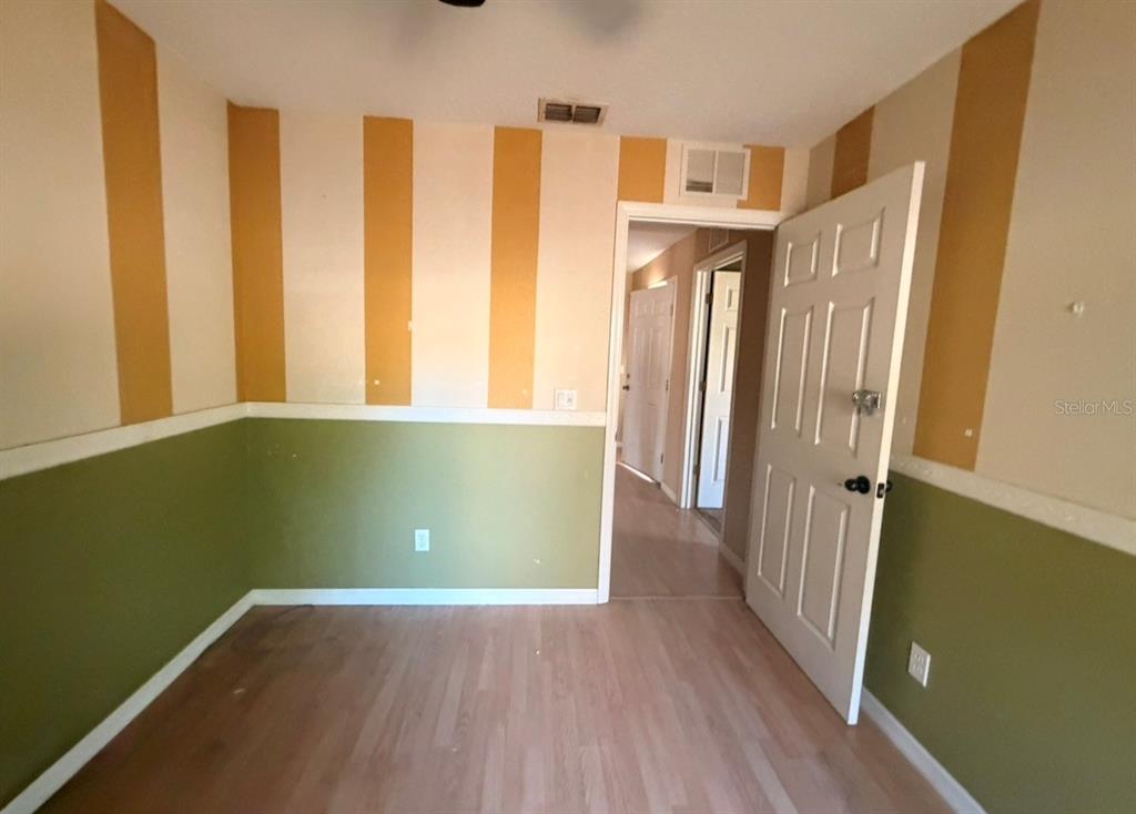 1221 Poe Street Inverness, FL 34450 - Photo 4 of 11 a view of a room with wooden floor and windows