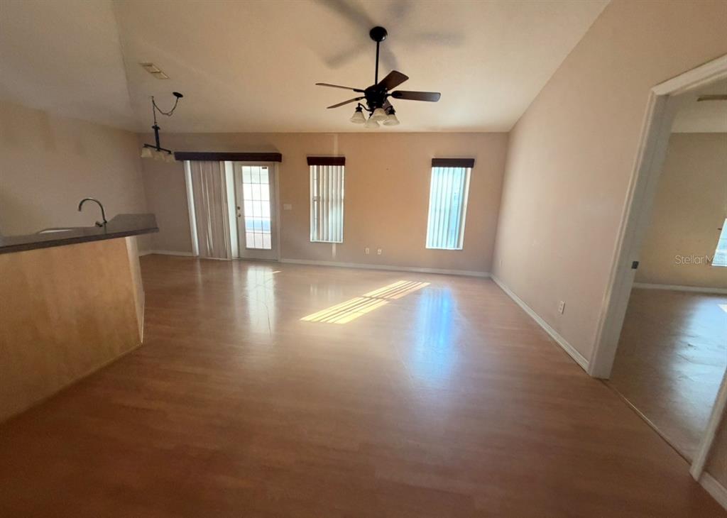 1221 Poe Street Inverness, FL 34450 - Photo 5 of 11 a view of empty room with wooden floor and fan