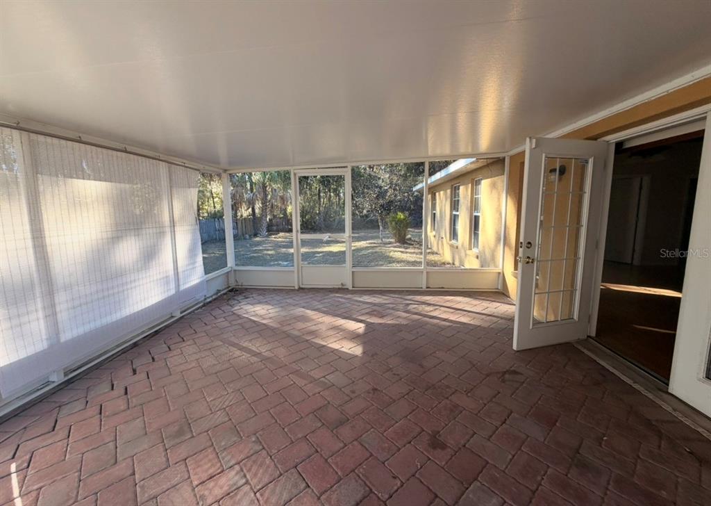 1221 Poe Street Inverness, FL 34450 - Photo 9 of 11 a view of empty room with floor to ceiling window and outdoor view