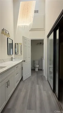 a spacious bathroom with a double vanity sink and a mirror