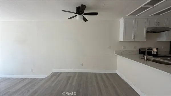 a kitchen with a sink wooden floor and cabinets