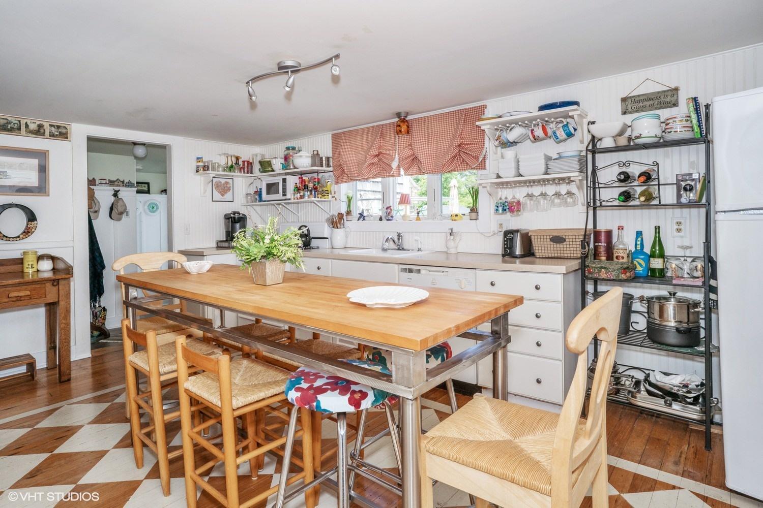 17 Wareham Avenue Onset, MA 02558 - Photo 4 of 15 a kitchen with a dining table and chairs with cabinets