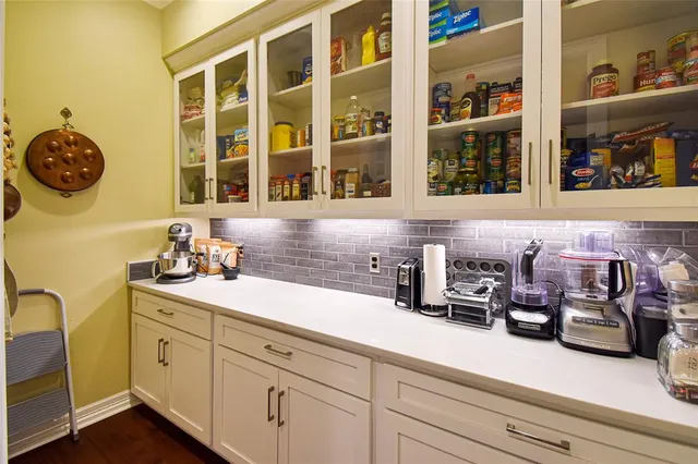 a kitchen with a sink and a clock on the wall