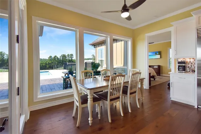 a dining room with furniture a chandelier and wooden floor