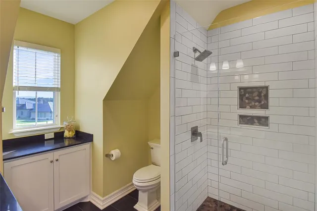 a bathroom with a shower toilet and sink