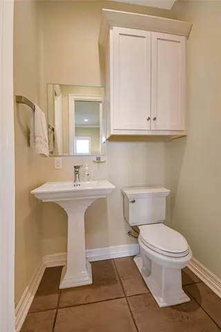 a bathroom with a sink a toilet and vanity