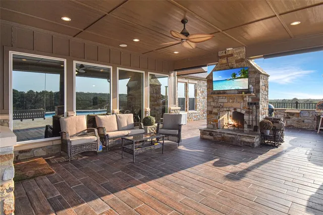 a living room with furniture a fireplace and a floor to ceiling window