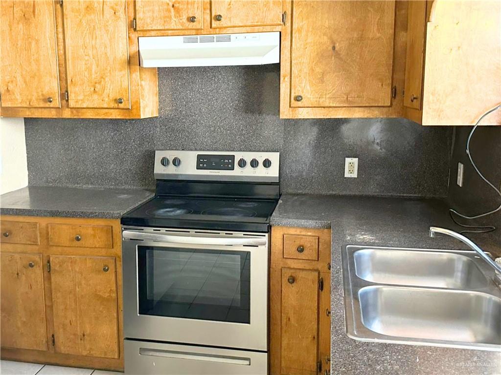 5007 East US Highway 83 Rio Grande City, TX 78582 - Photo 21 of 26 a kitchen with stainless steel appliances granite countertop a stove and a sink