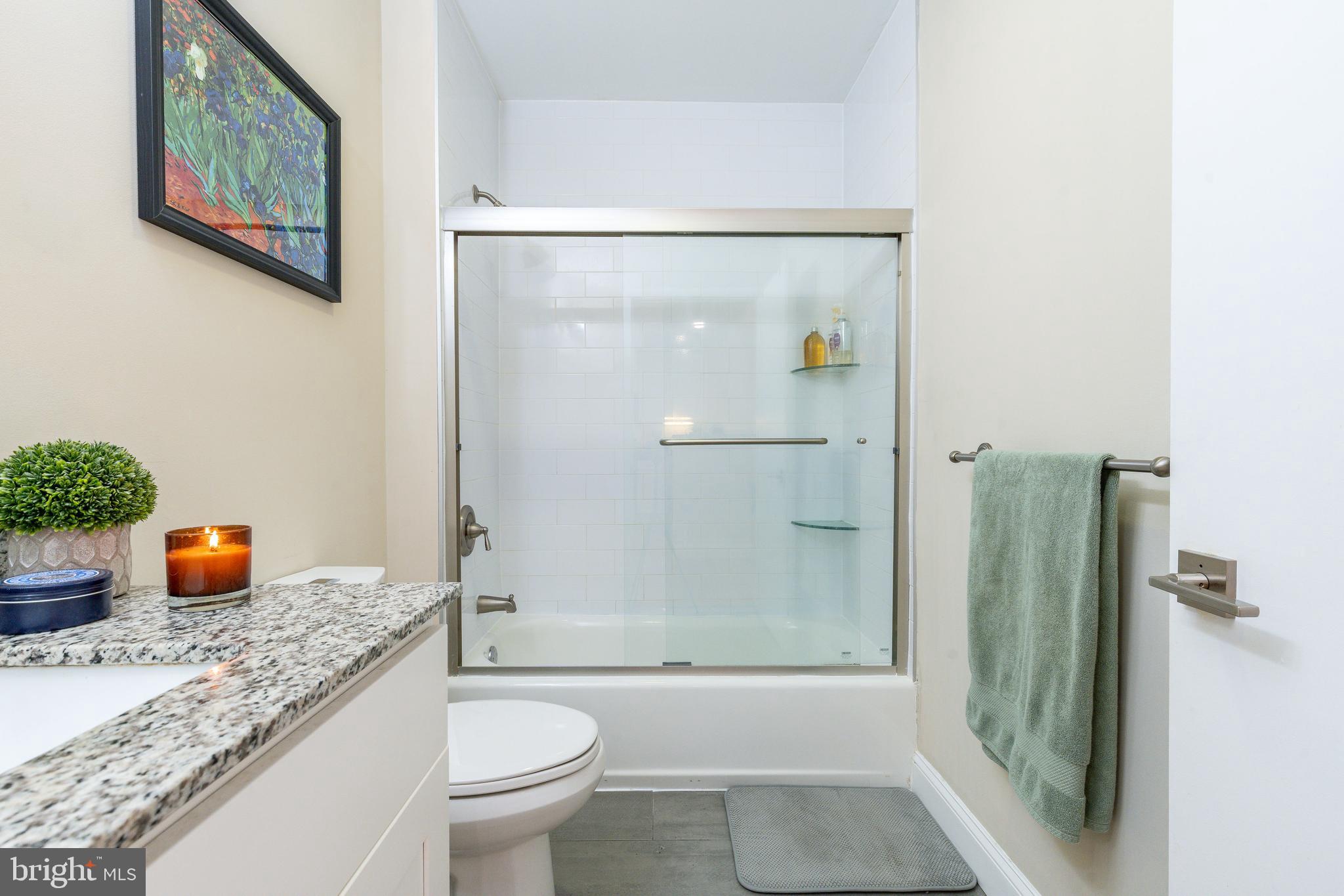 1900 Hamilton Street, Unit C6 Philadelphia, PA 19130 - Photo 13 of 37 a bathroom with a granite countertop sink toilet and shower