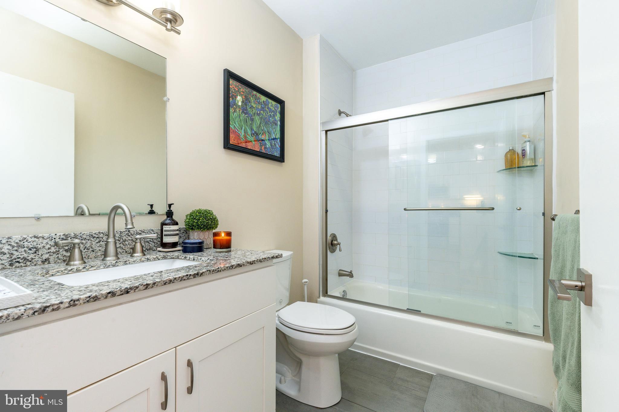1900 Hamilton Street, Unit C6 Philadelphia, PA 19130 - Photo 14 of 37 a bathroom with a granite countertop sink toilet and shower