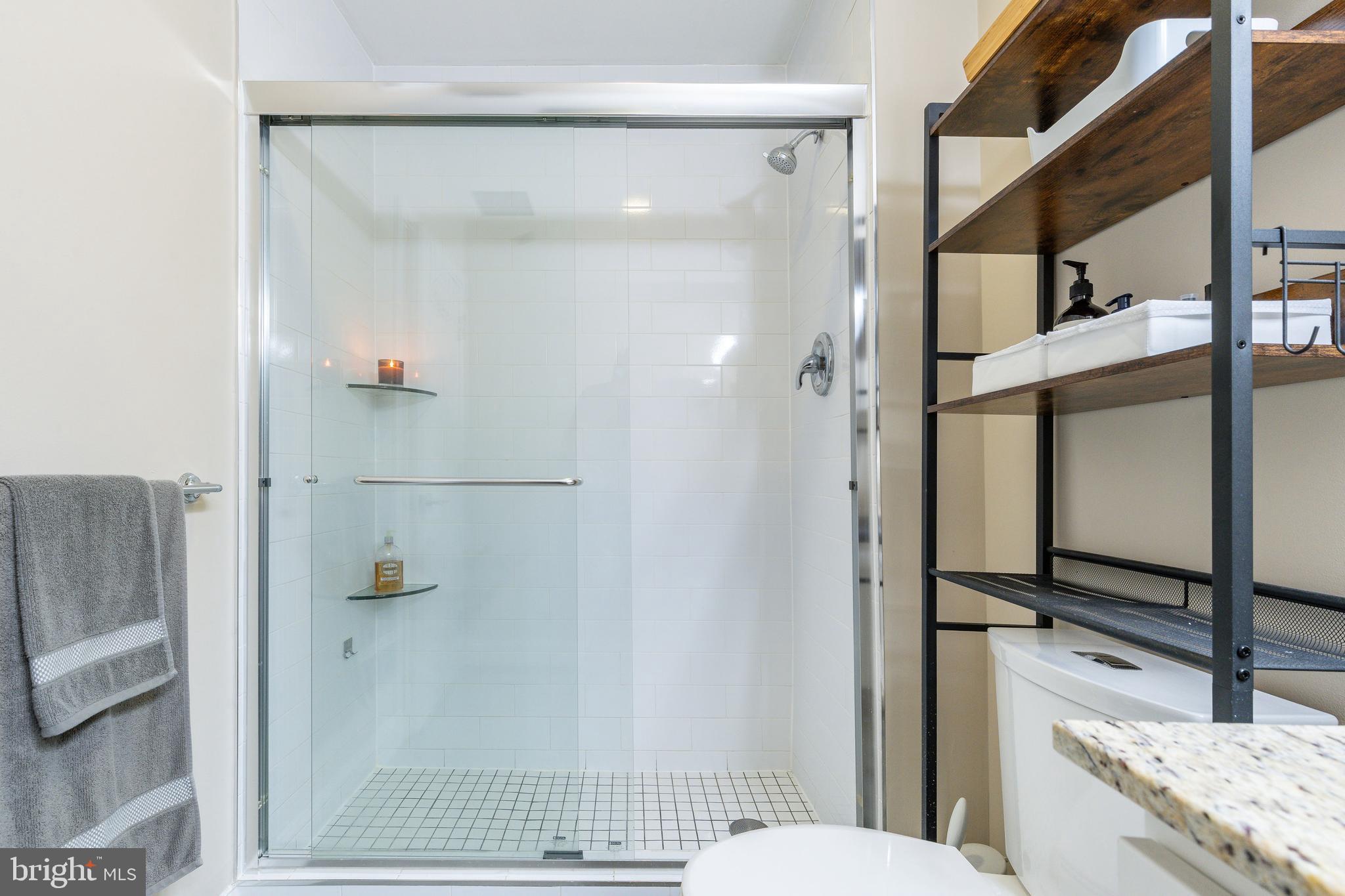 1900 Hamilton Street, Unit C6 Philadelphia, PA 19130 - Photo 21 of 37 a bathroom with a granite countertop shower mirror and toilet