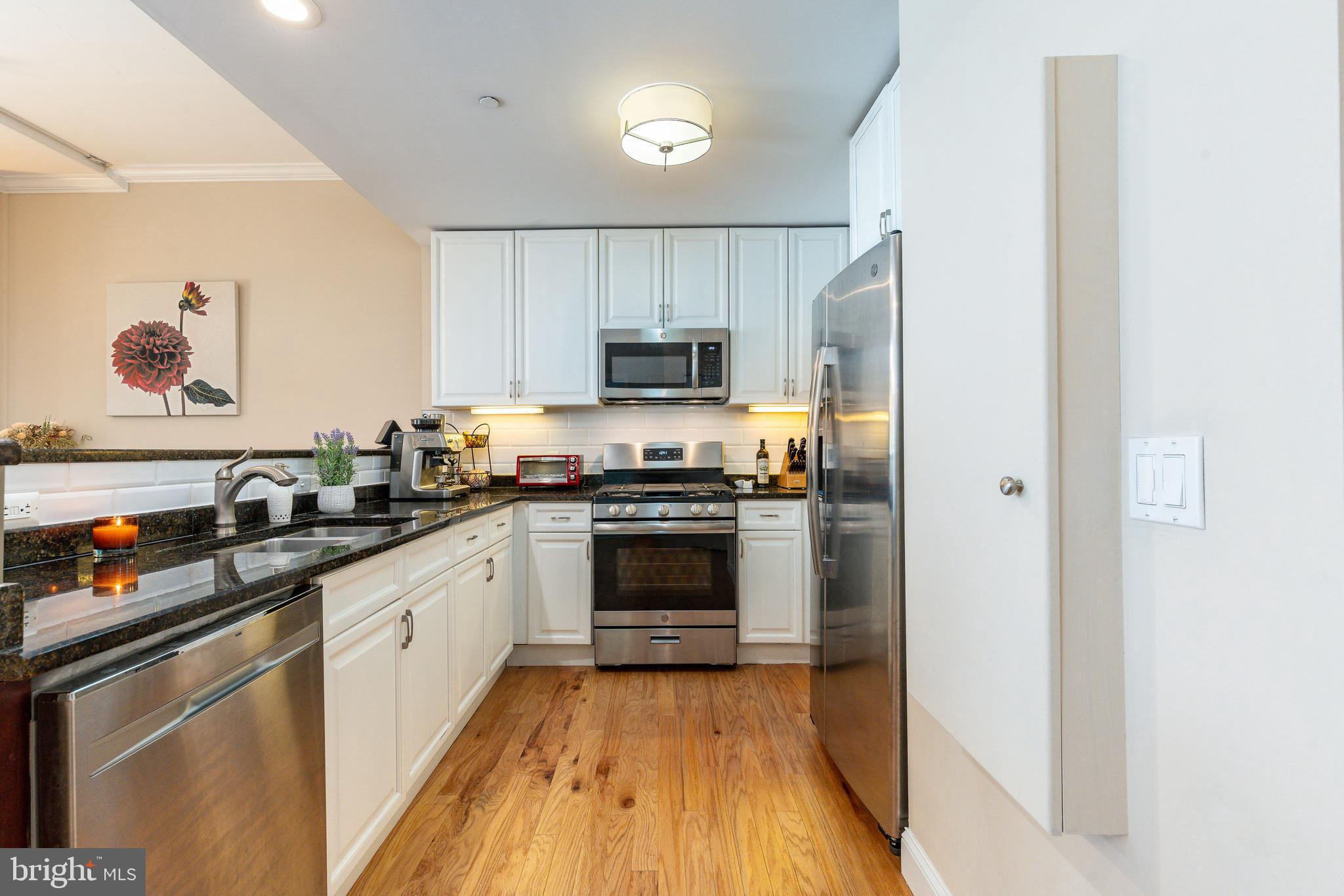 1900 Hamilton Street, Unit C6 Philadelphia, PA 19130 - Photo 10 of 37 a kitchen with granite countertop a refrigerator stove top oven and sink