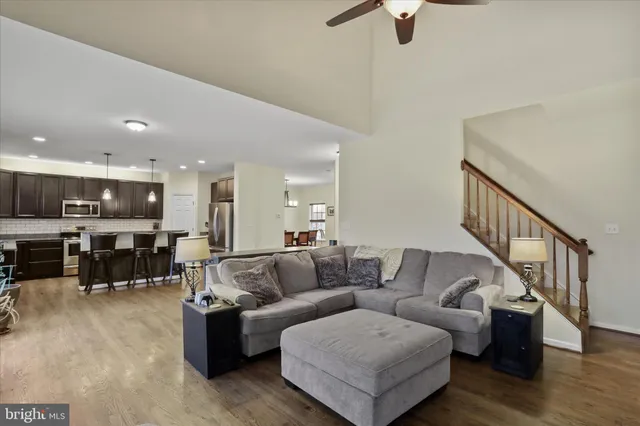 a living room with furniture and a view of kitchen