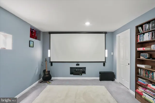 a view of an empty room with window and a flat screen tv