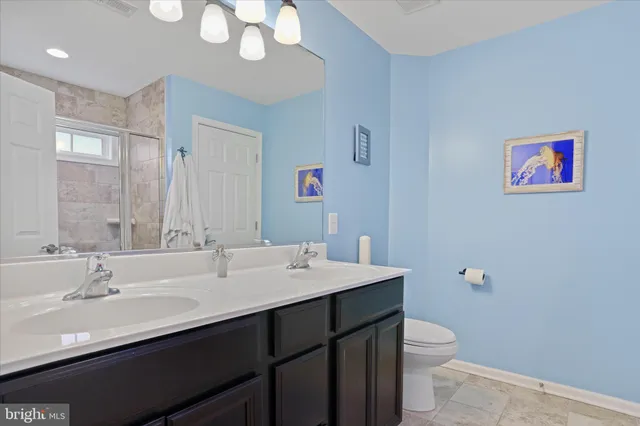 a bathroom with a sink a toilet a mirror and vanity