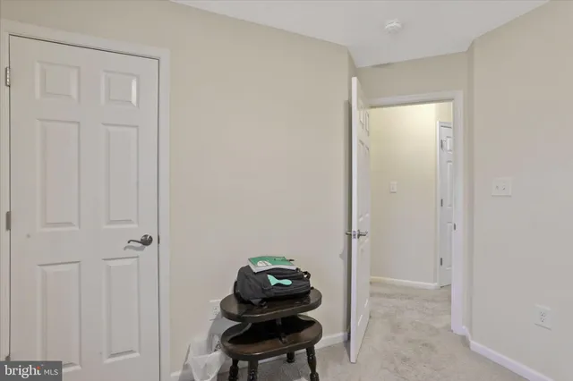a bathroom with a granite countertop toilet sink and mirror